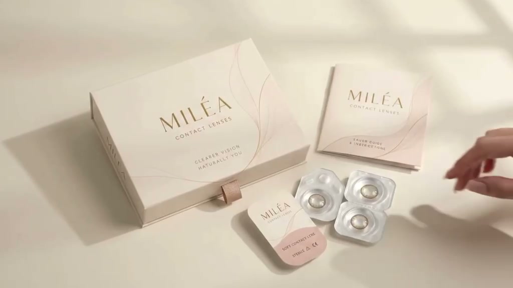 MILÉA box, care guide and lenses arranged on a cream surface